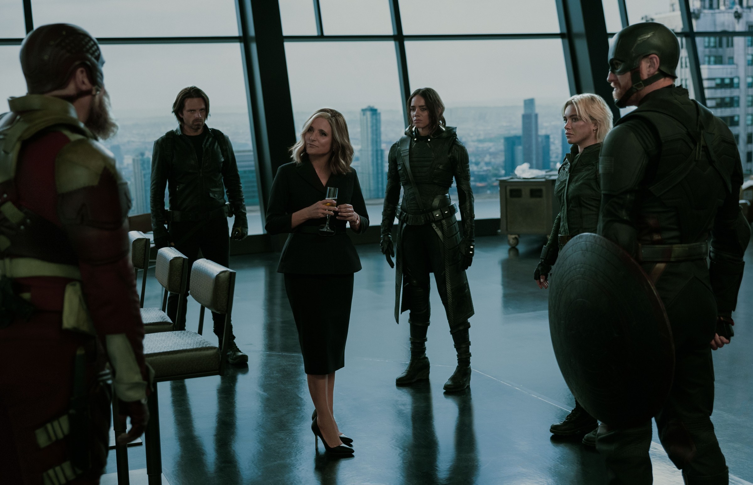 Allegra de Fontaine (Julia Louis-Dreyfus) stands amid the Thunderbolts in Tony Stark’s penthouse in Avengers Tower in Thunderbolts*